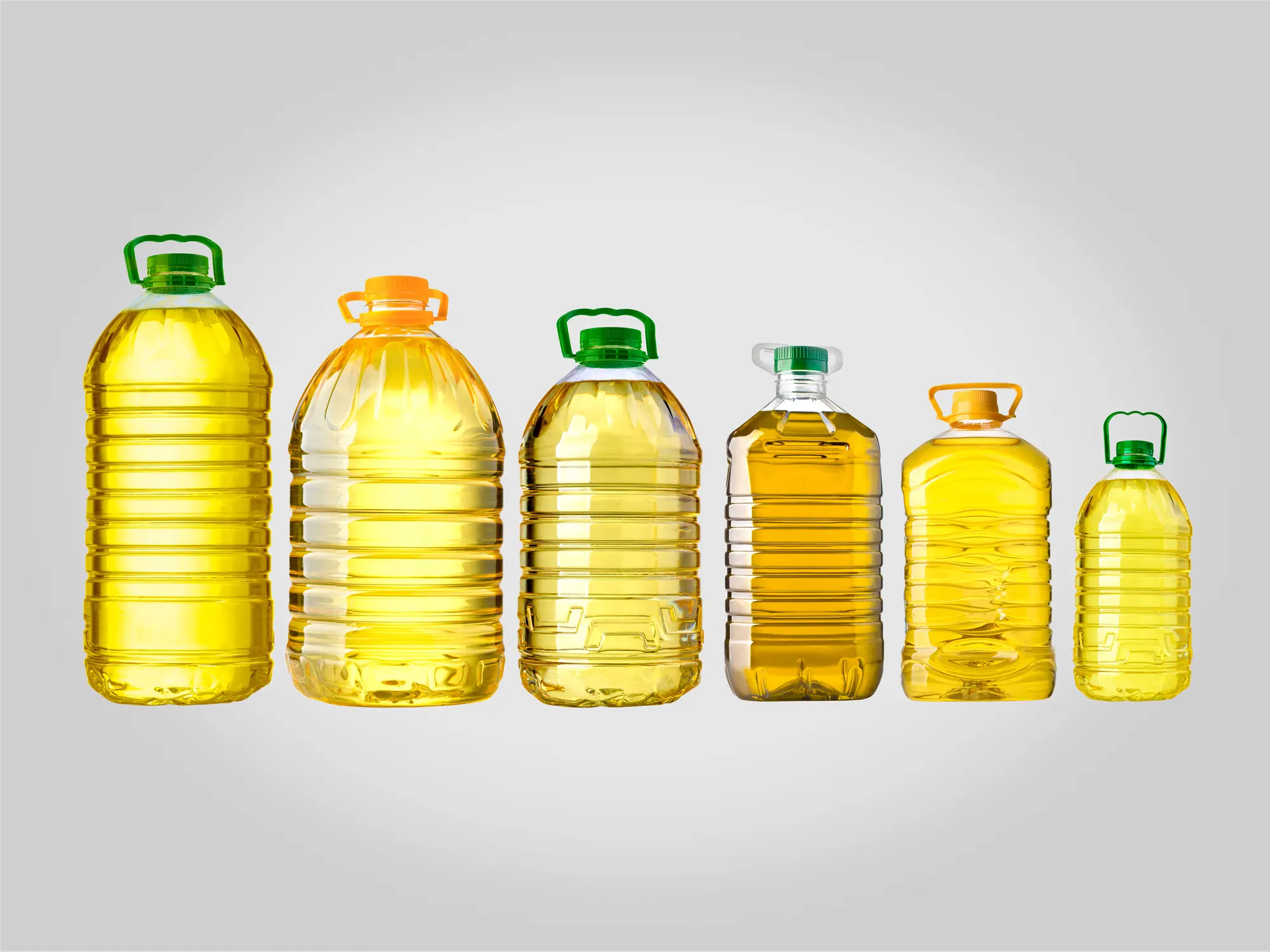 Oil Carboys with Rigid Handles - Application with Linear XHN Machines Oil carboys of different sizes with rigid handles (neck handles), applied with linear XHN machines